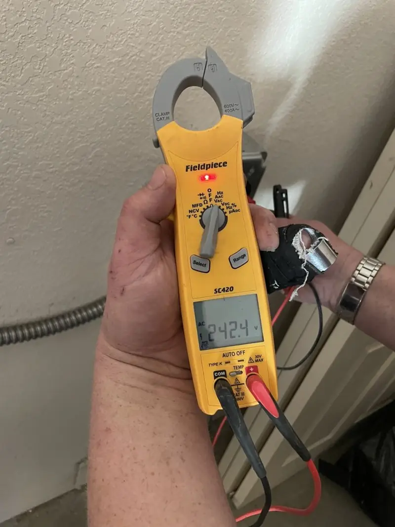 Voltage testing with clamp meter during Recessed Lighting Installation in Bright